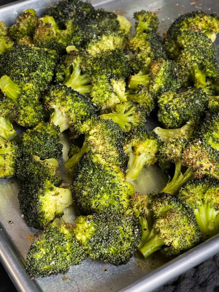 Roasted broccoli on a baking sheet.