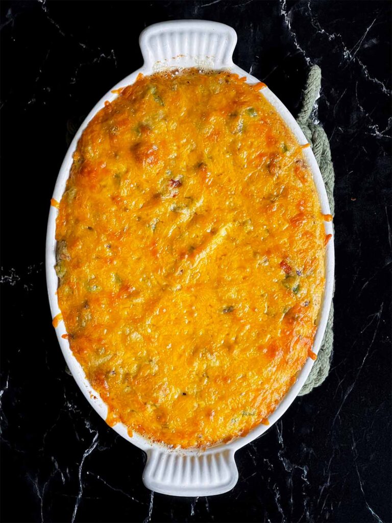 Baked sausage and cheese grits in a casserole dish.