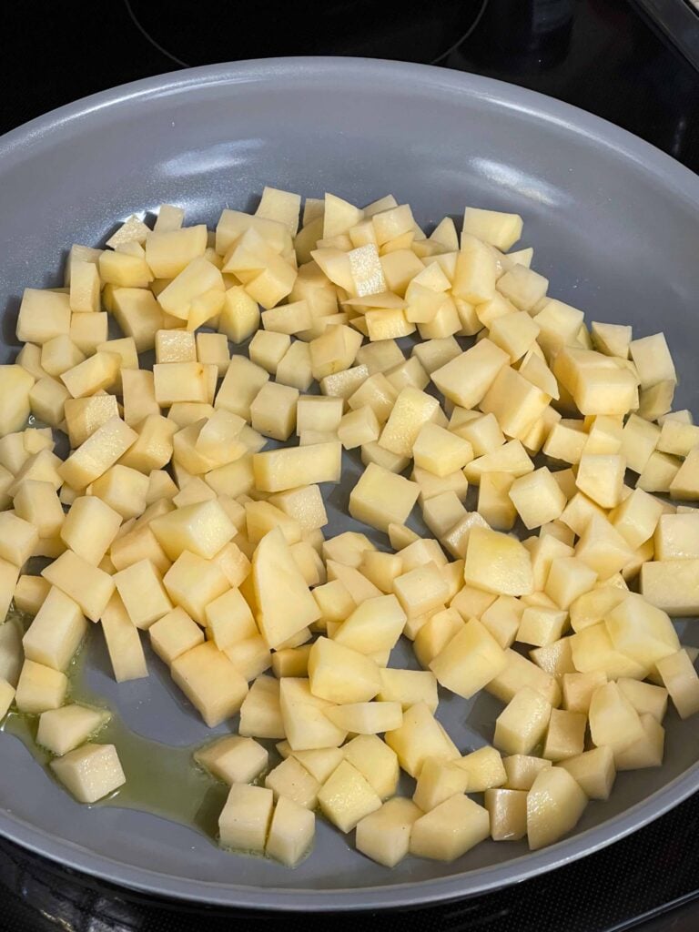 Diced potatoes in a skillet.