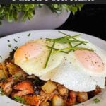 Smoked pulled pork hash garnished with parsley in a white bowl.