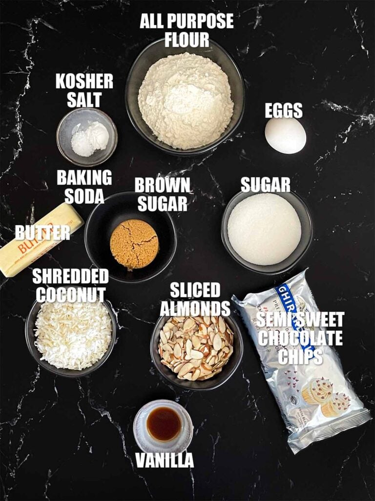 Almond joy cookies recipe ingredients on a dark surface.