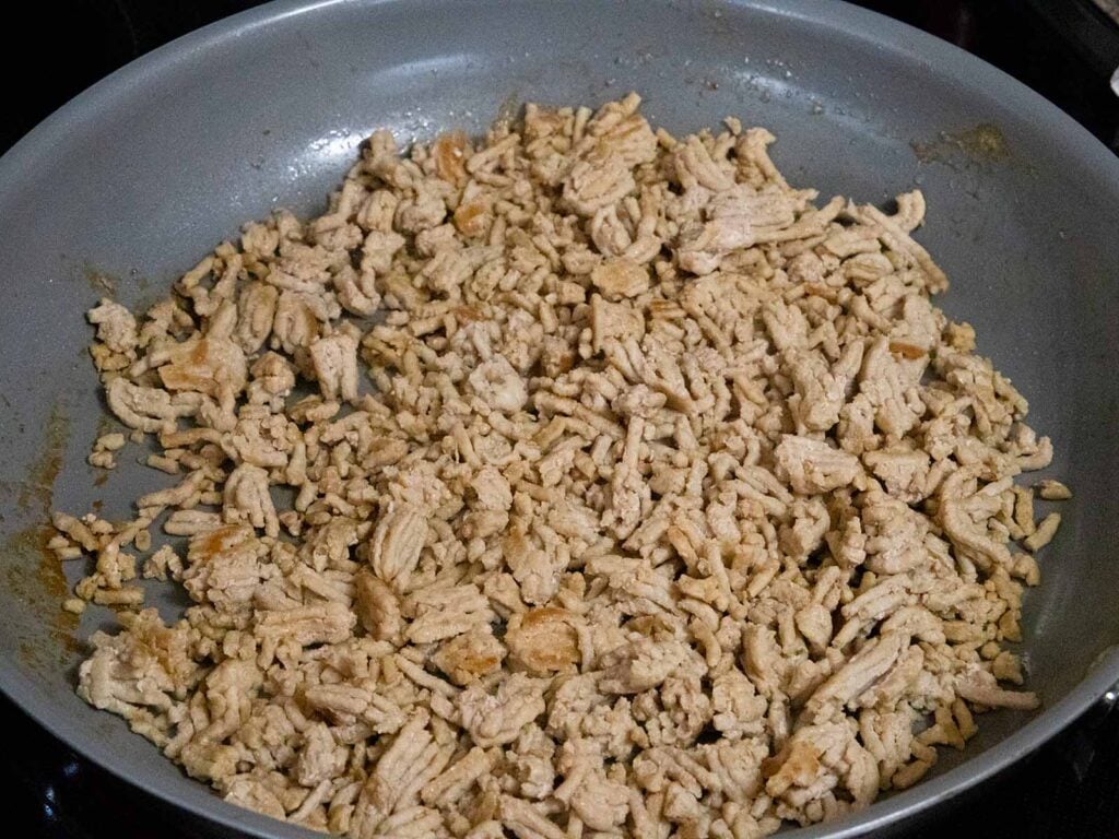 Cooked ground chicken in a skillet.