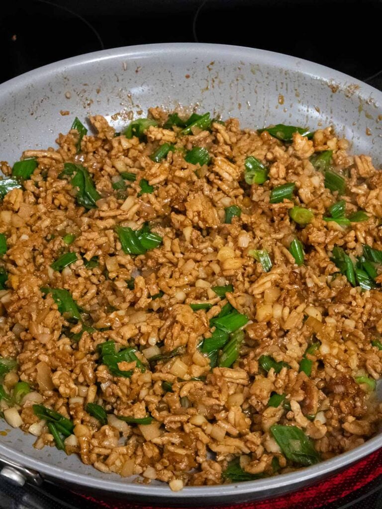 Filling for chicken lettuce wraps in a skillet.