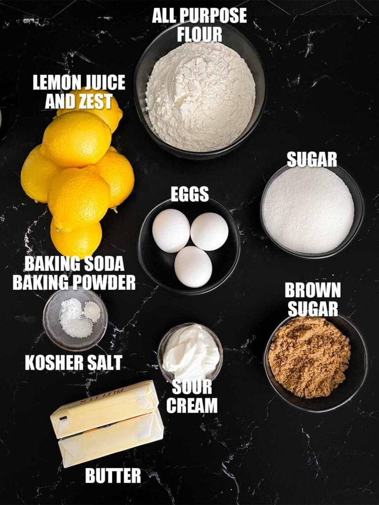 Lemon crumb cake recipe ingredients on a dark surface.