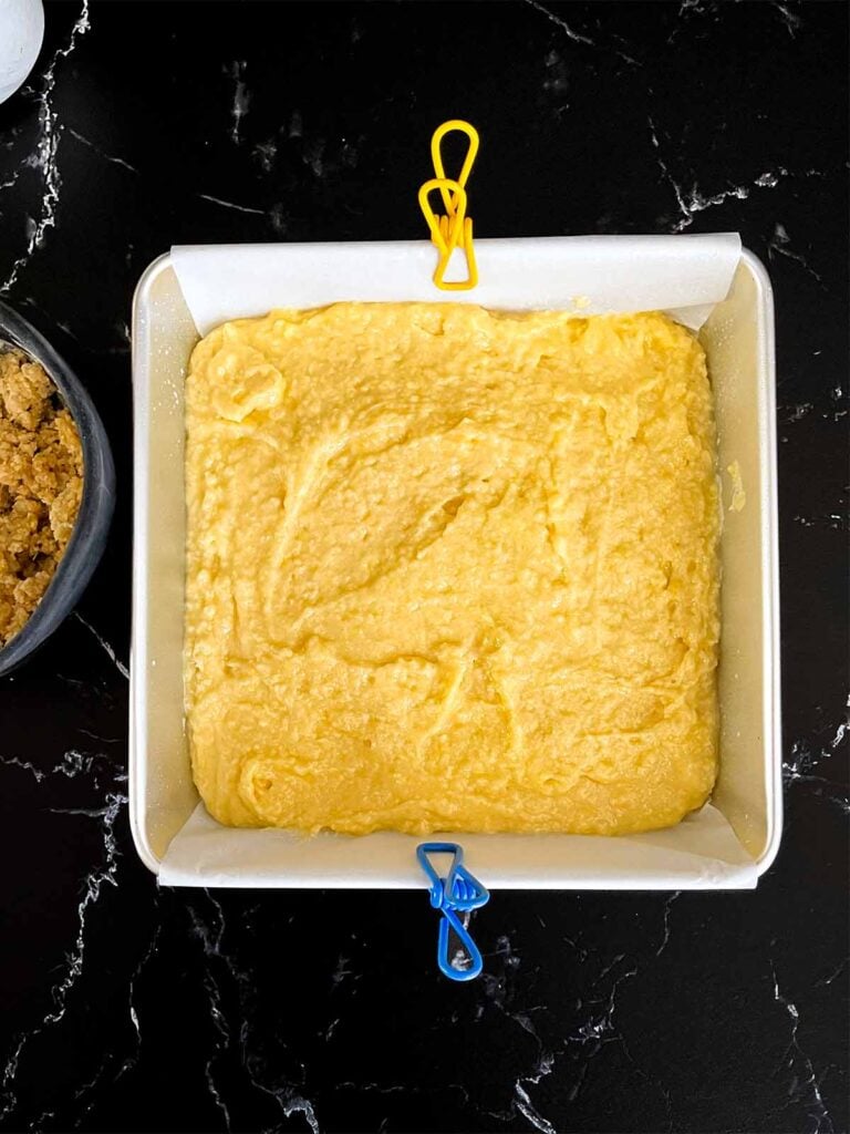 Lemon crumb cake batter in a prepared baking pan.
