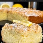 A slice of lemon crumb cake dusted with powdered sugar and garnished with a lemon slice on a dark plate on a dark surface.