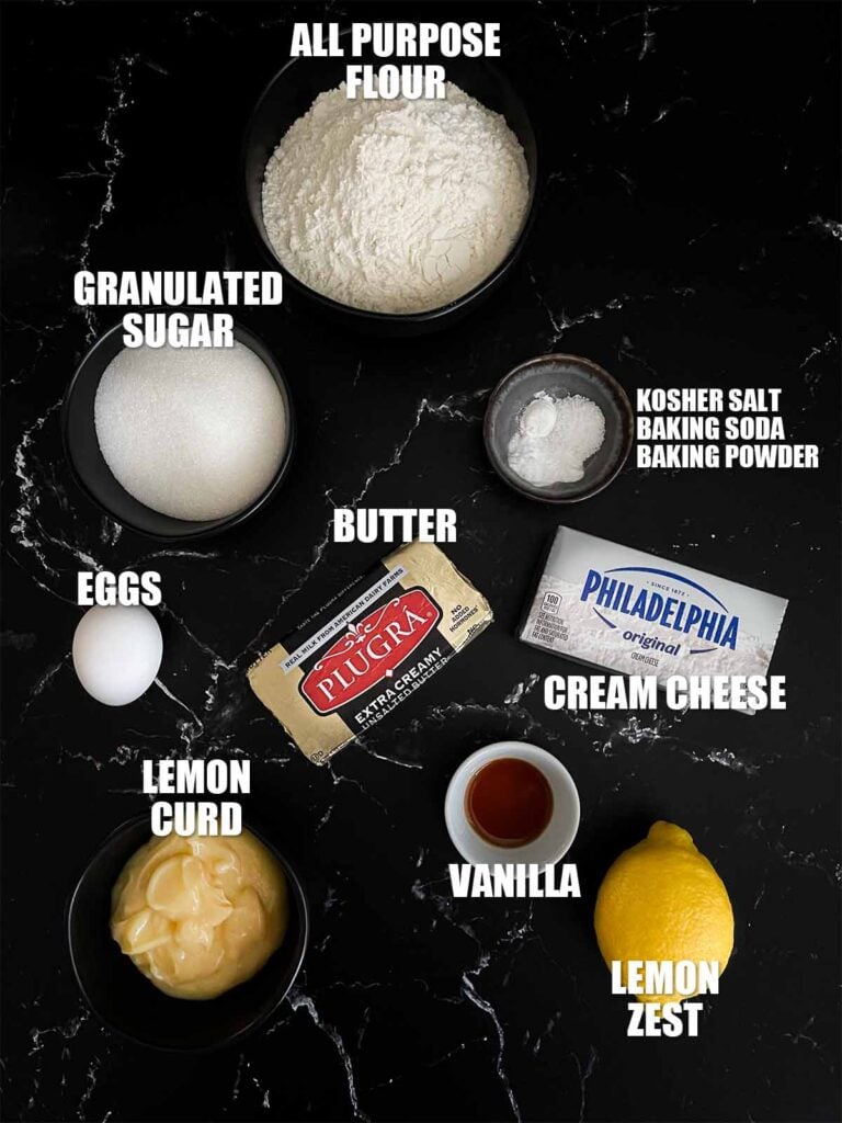 Lemon thumbprint cookies recipe ingredients on a dark surface.