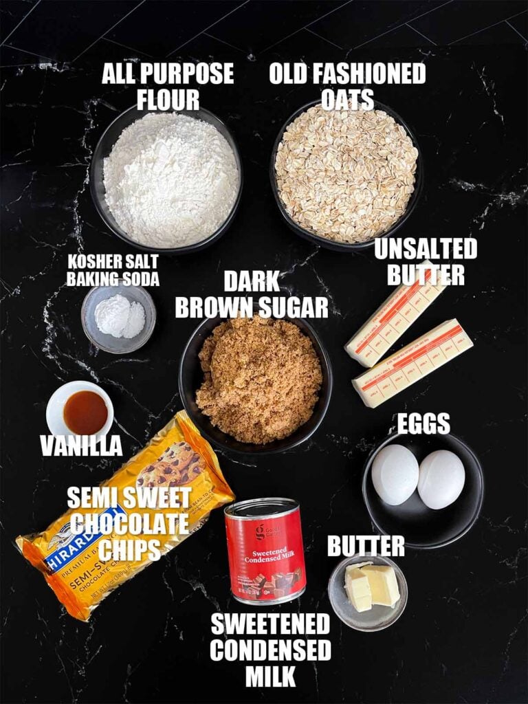 Oatmeal fudge bars recipe ingredients on a dark surface.