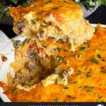 Sausage and cheese grits casserole in a white baking dish with a portion served.