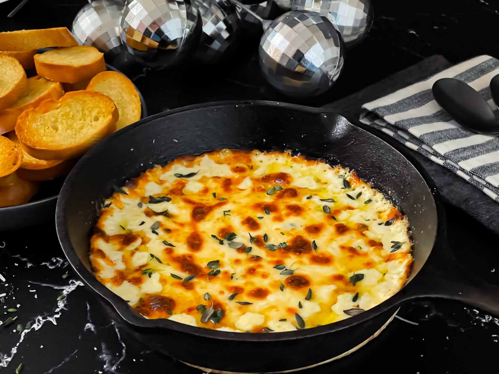 Baked ricotta dip in a small cast iron skillet.