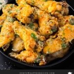 Garlic Parmesan chicken wings on a dark bowl.