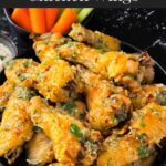 Garlic Parmesan chicken wings on a dark bowl.
