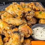 Garlic Parmesan chicken wings on a dark bowl.