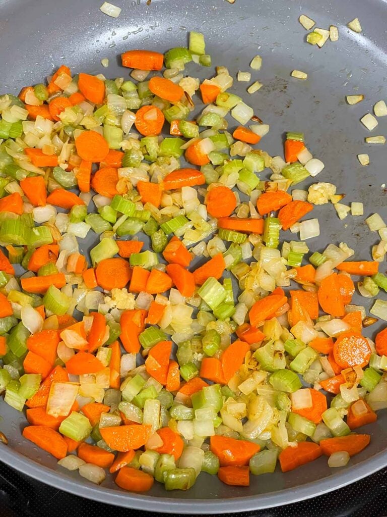 Cooked mirepoix in a skillet.