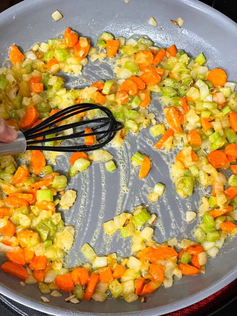 Mirepoix with a roux cooking in skillet.
