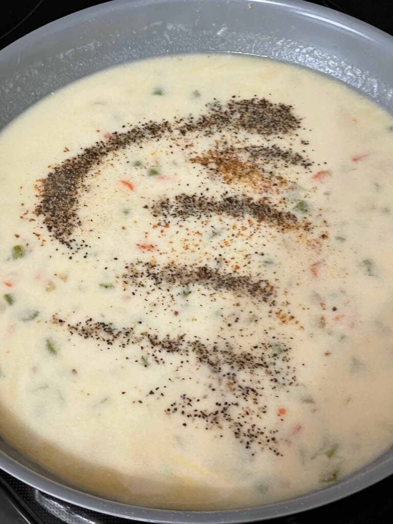 The sauce for chicken stuffing casserole in a skillet.