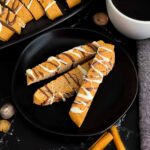 Chai biscotti on a dark plate.