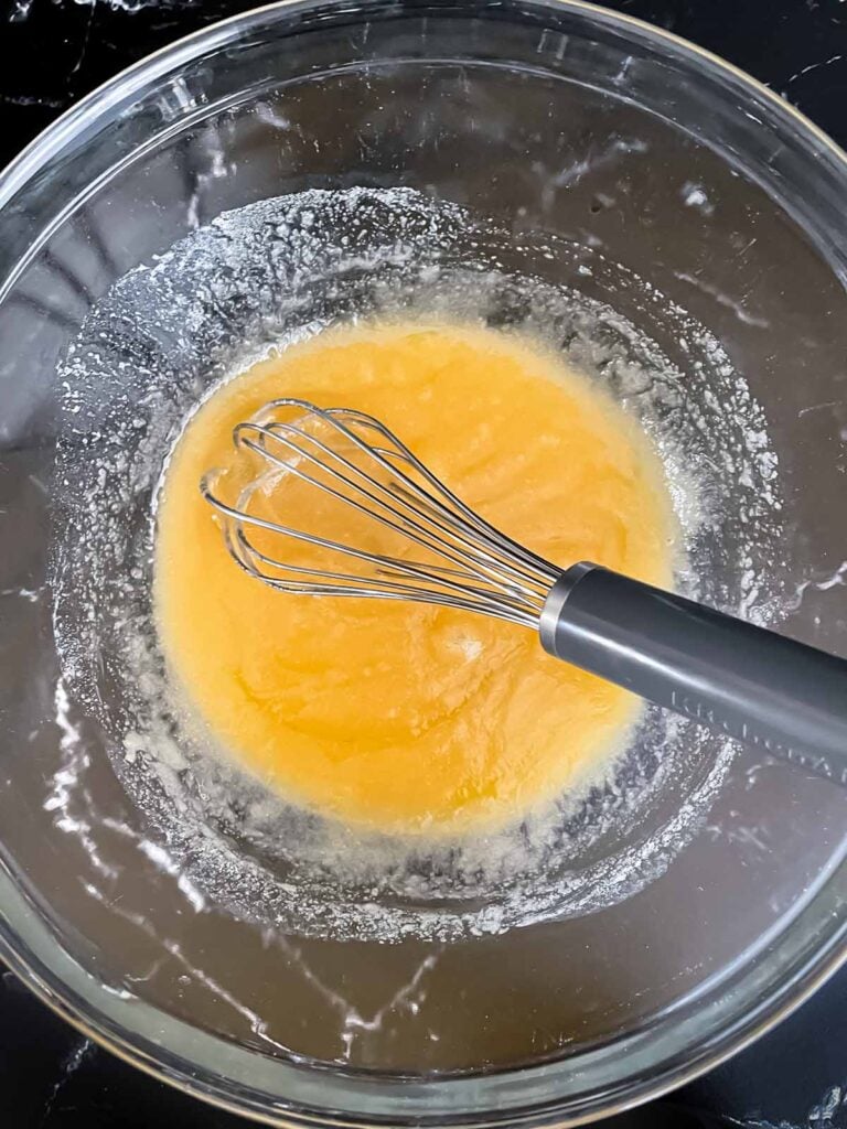 An butter and sugar mixture mixed in a glass bowl.