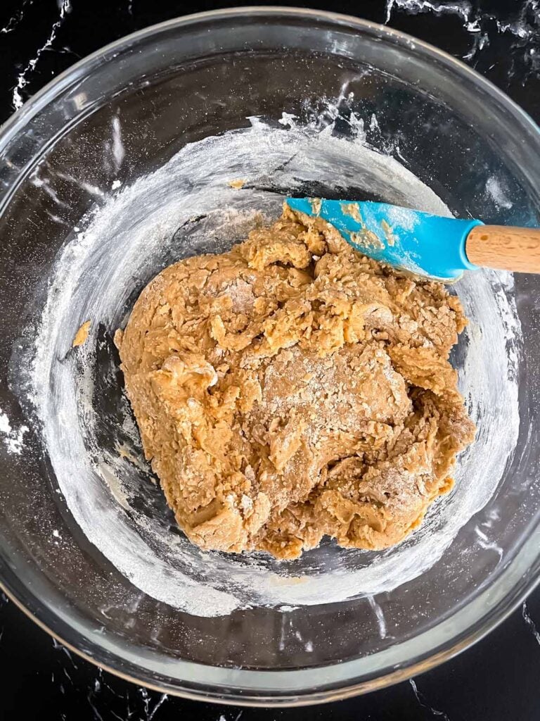 Chai biscotti dough in a glass bowl.