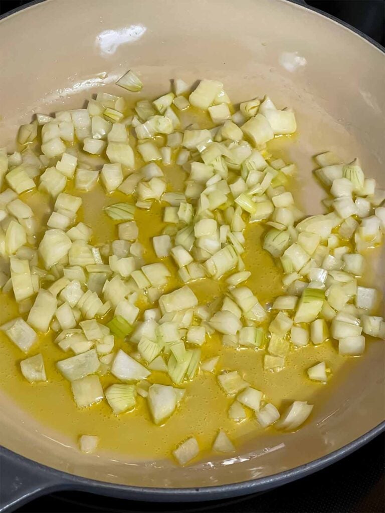Onions in olive oil cooking.