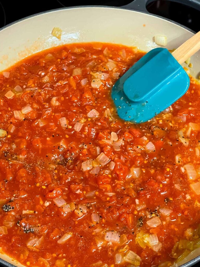 A tomato sauce cooking in a skillet.