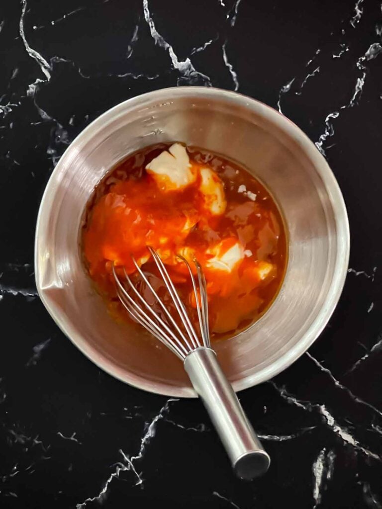 Ingredients for bang bang sauce in a bowl.