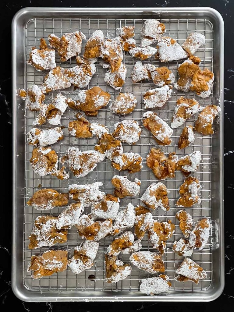 Bite sized chicken thigh pieces covered in cornstarch.
