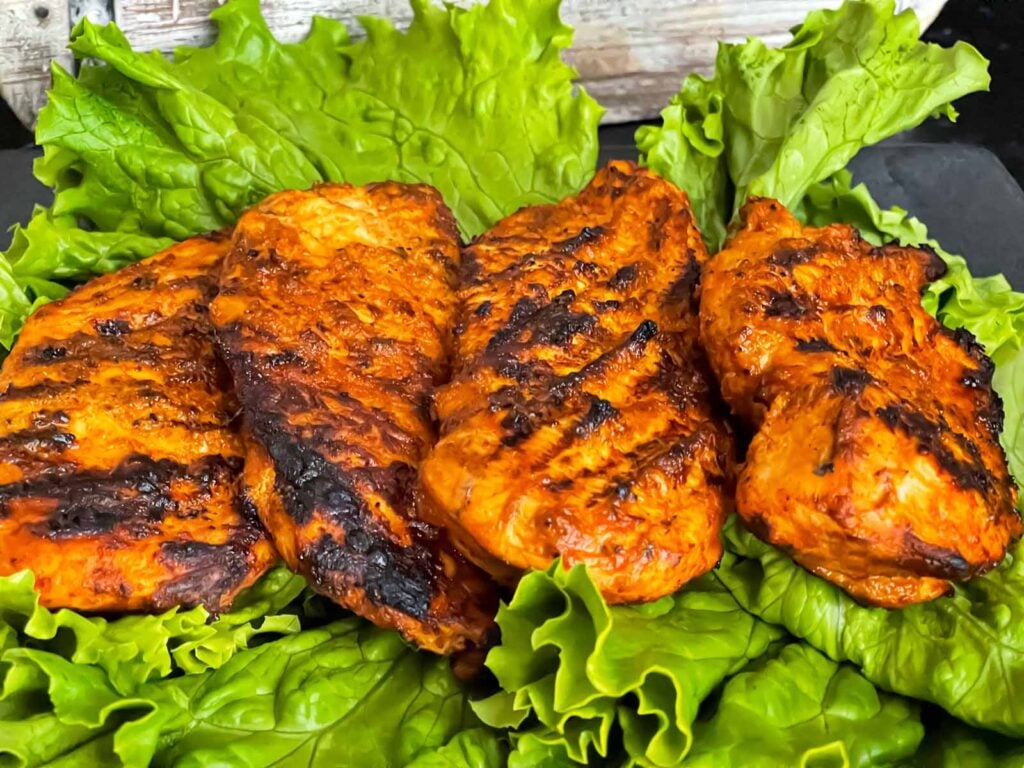 Southwest grilled chicken on a bed of lettuce.