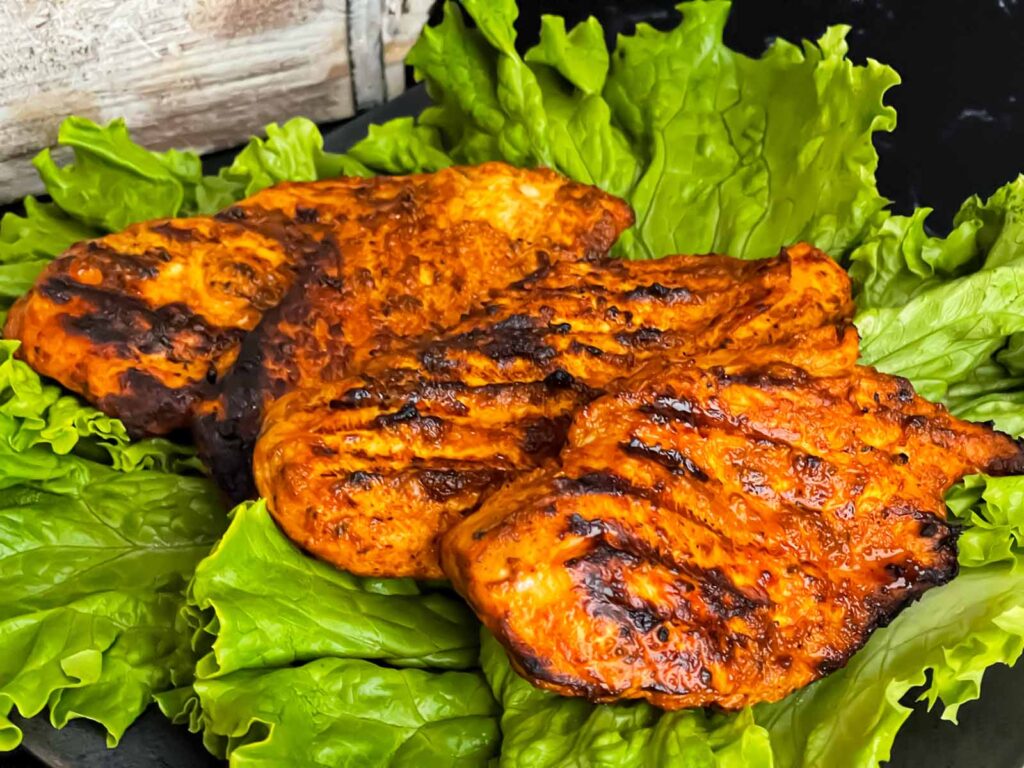 Southwest grilled chicken on a bed of lettuce.
