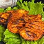 Southwest grilled chicken on a bed of lettuce.