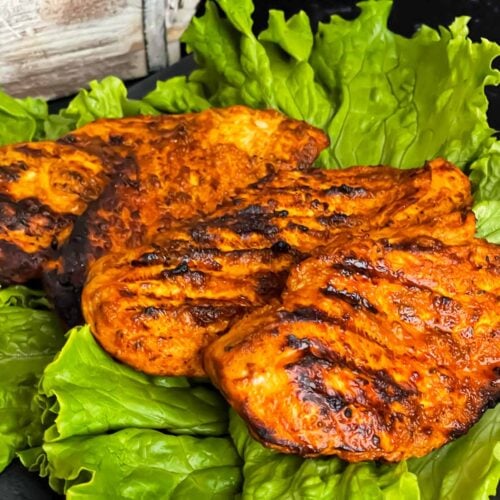 Southwest grilled chicken on a bed of lettuce.