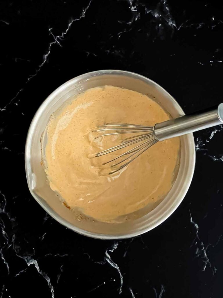 Southwest sauce ingredients whisked together in a bowl.
