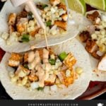 Adding a southwest sauce to grilled chicken tacos.