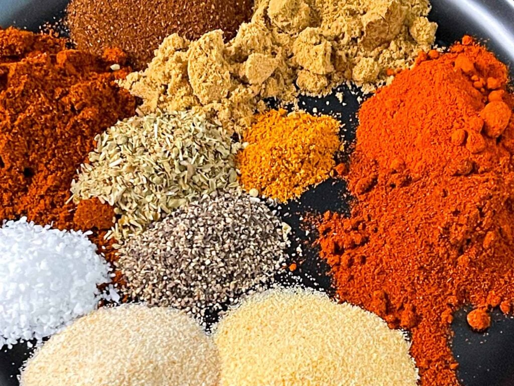 Spices on a black plate.