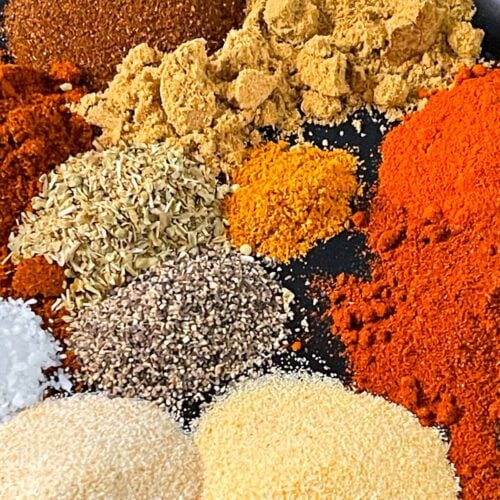 Spices on a black plate.