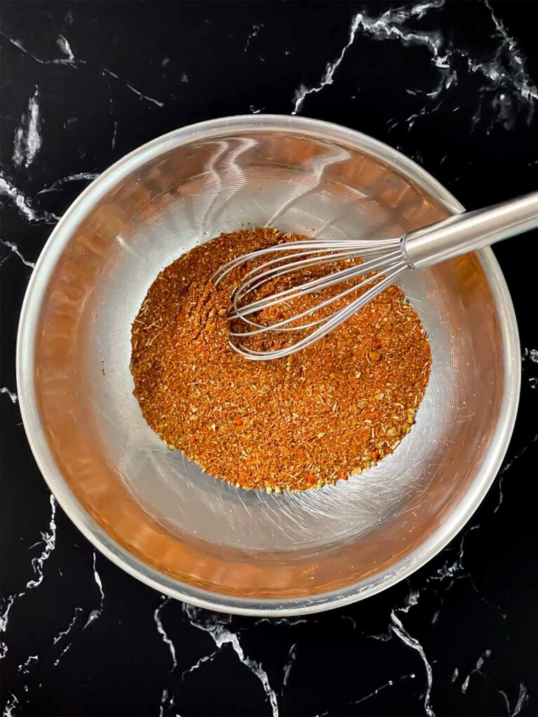 Southwest spices in a stainless steel bowl, mixed.