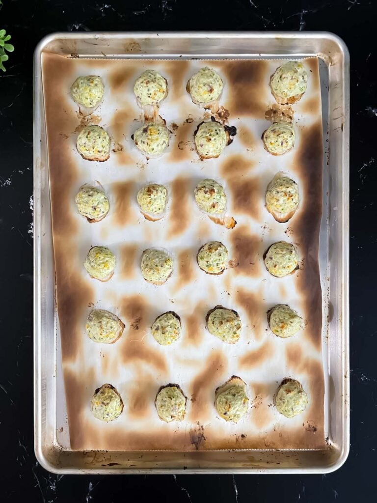 Cooked chicken jalapeno meatballs on a baking sheet.