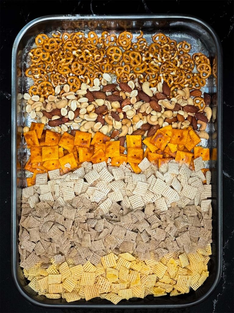 Ingredients for Firecracker Chex Mix in a baking dish.