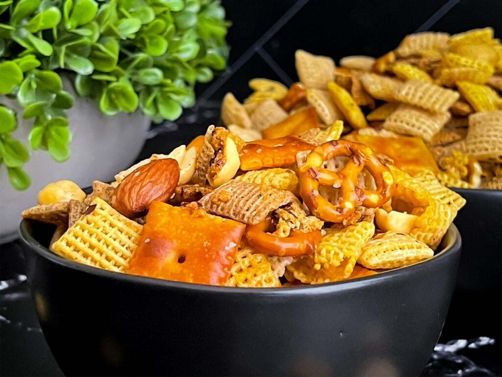 Firecracker Chex Mix in a dark bowl.