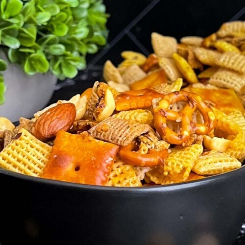 Firecracker Chex Mix in a dark bowl.