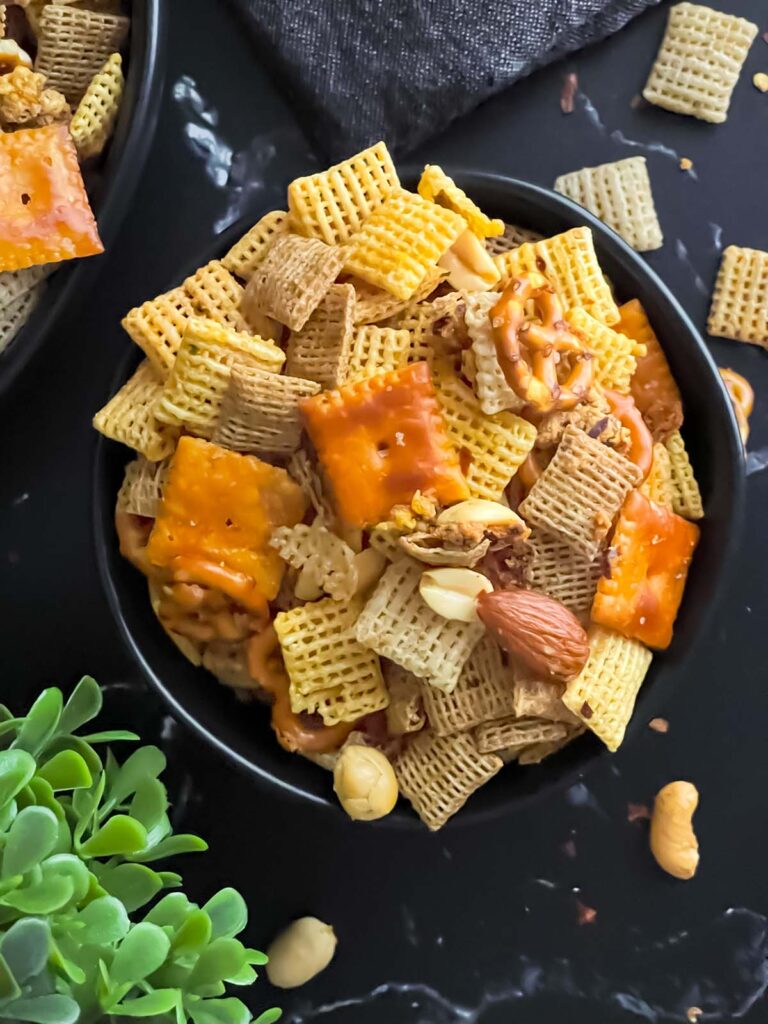 Firecracker Chex Mix in a dark bowl.