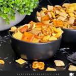 Firecracker Chex Mix in a dark bowl.