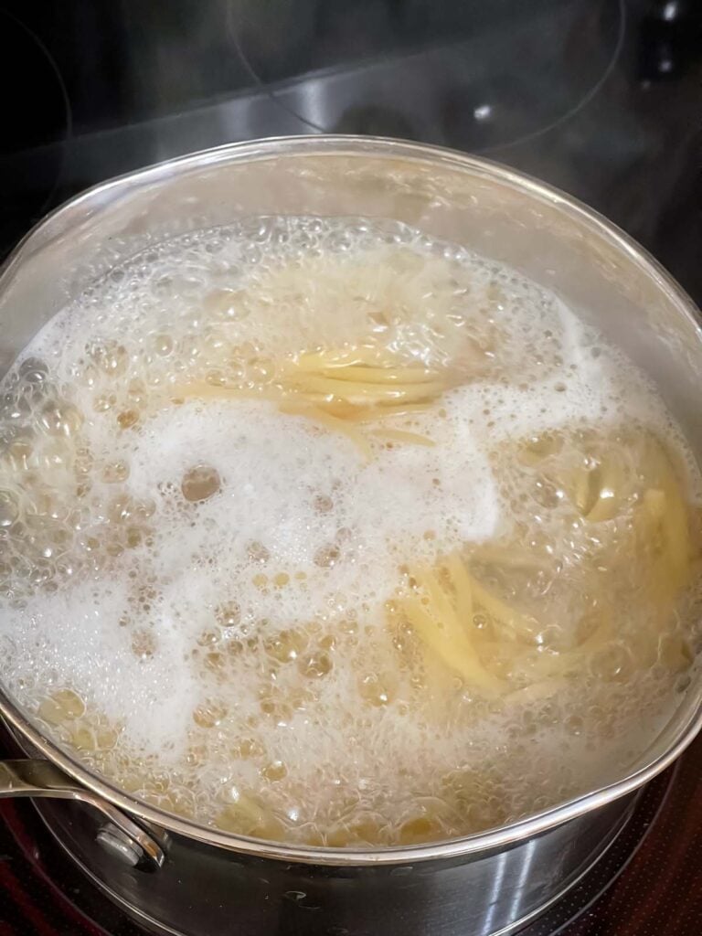 Bucatini boiling in water.