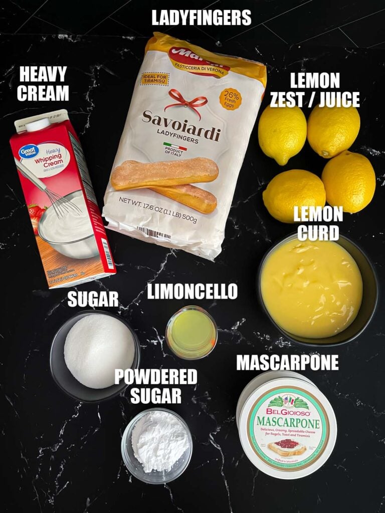 Limoncello tiramisu recipe ingredients on a dark surface.