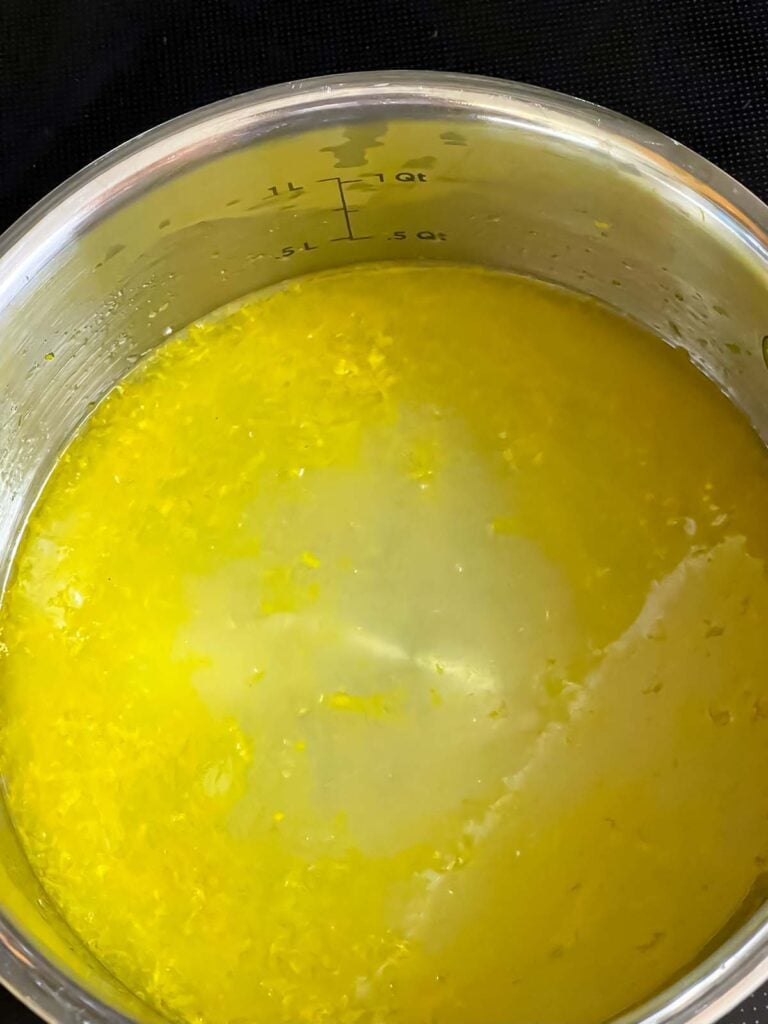 Limoncello syrup prepared in a small metal sauce pan.