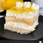 Limoncello tiramisu serving on a dark plate on a dark surface.
