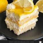 Limoncello tiramisu serving on a dark plate on a dark surface.