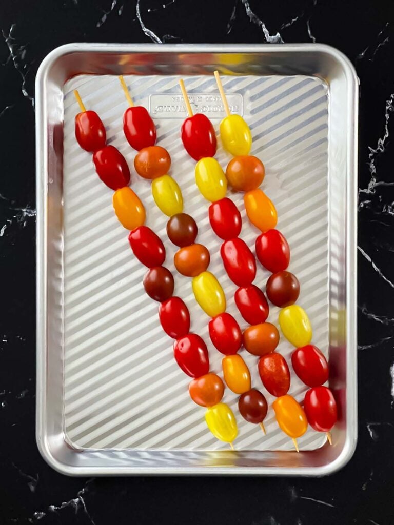 Grape tomatoes on skewers.