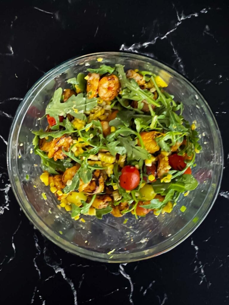 Shrimp and corn salad in a glass bowl.
