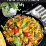 Shrimp and corn salad in a dark bowl.